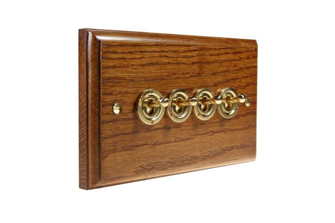 toggle-switch-4gang-2way-polished-brass-medium-oak